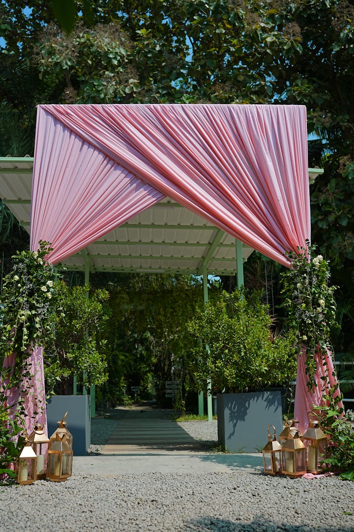 elegant-outdoor-wedding-arch-with-pink-drapes-33468986